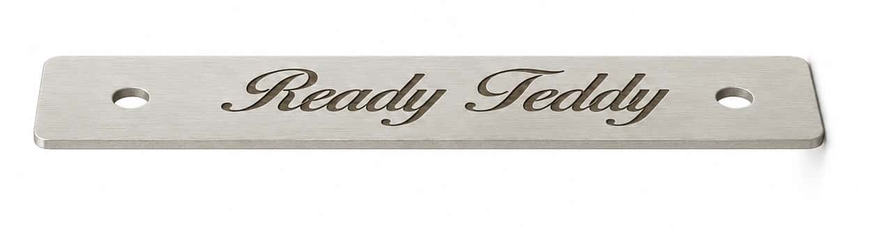 Photographed silver-coloured plate engraved with Ready Teddy in English script